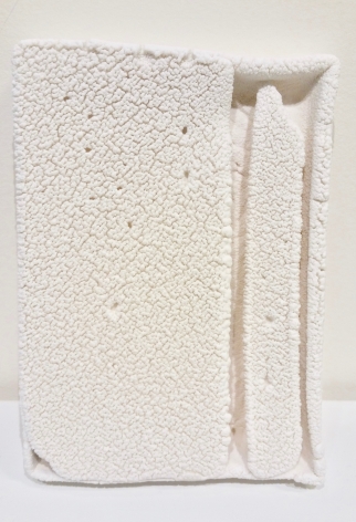 Cary Esser "Parfleche", solid-cast earthenware with slip, 7.5" x 5.37" x 1.25", 2017 (sold), a rectangular ceramic "parfleche" , cracked warm white surface with two strong vertical elements on the right side